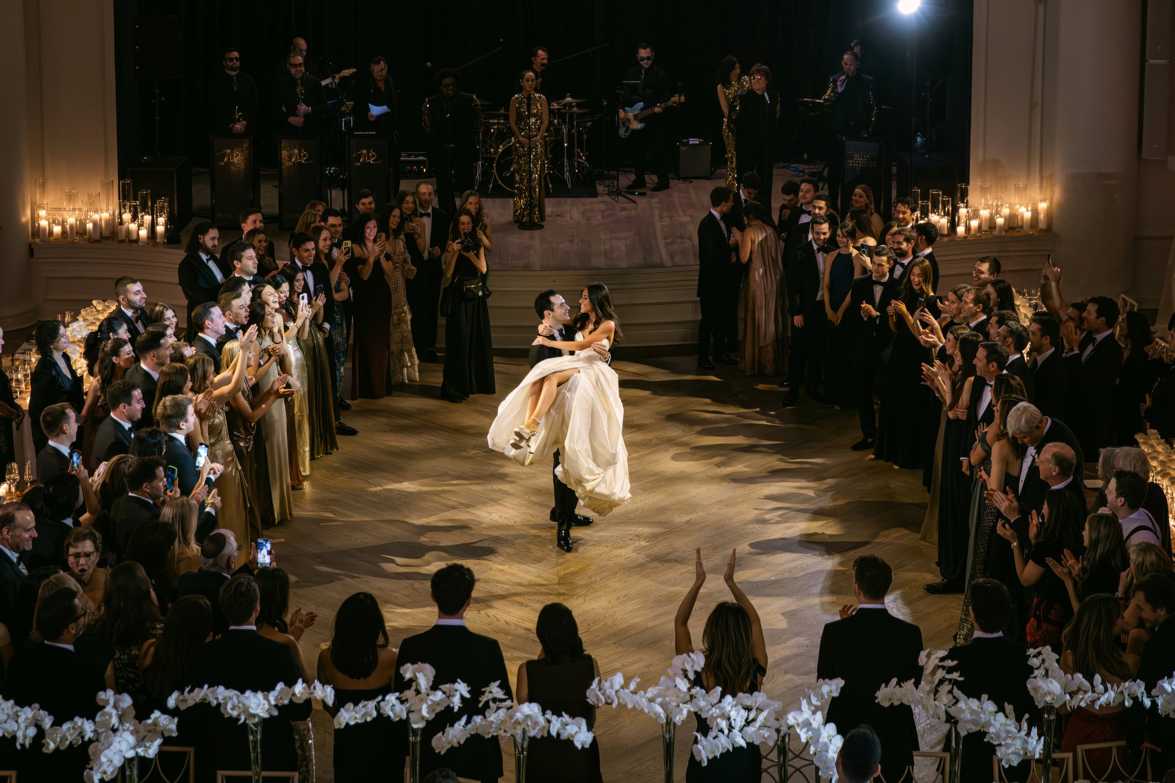 Wedding guests gathered in an illuminated ballroom